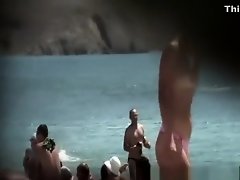Topless blonde woman at beach on Watchteencam.com